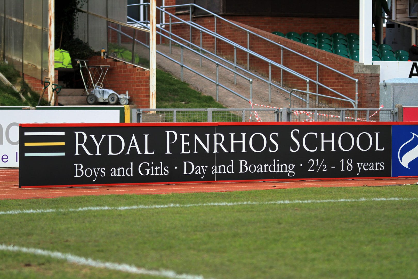 Hoardings in situ at pitch side advertising an independent school