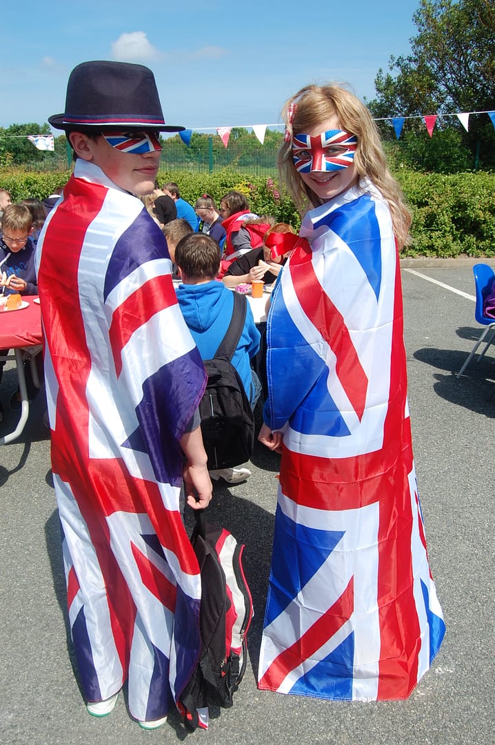Two pupils draped in union flags for the Jubilee Fun Day celebrating the Queen's Diamond Jubilee.