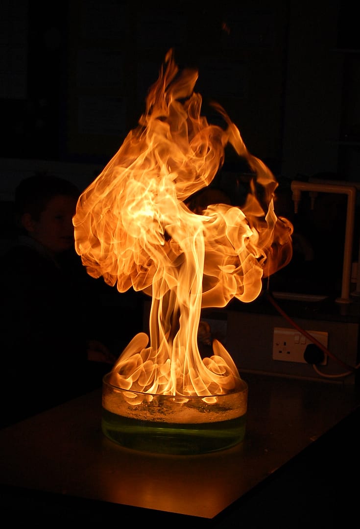 A burst of flame from a dish resembling an ace of spades.